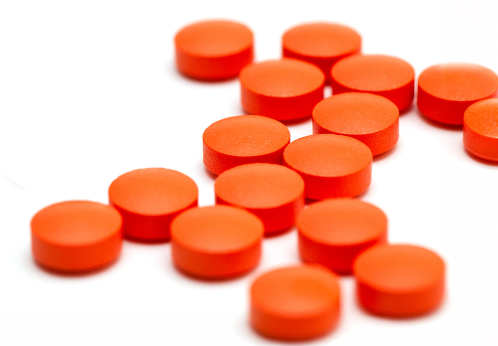 orange pills over white